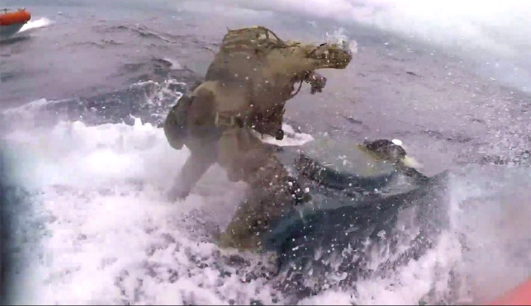 WATCH: Coast Guardsman jumps onto moving narco submarine and punches it