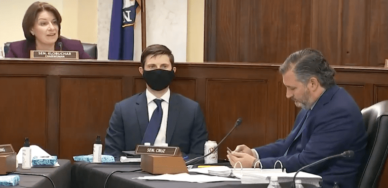 Cruz scrolls through phone as Klobuchar questions him about 2020 election