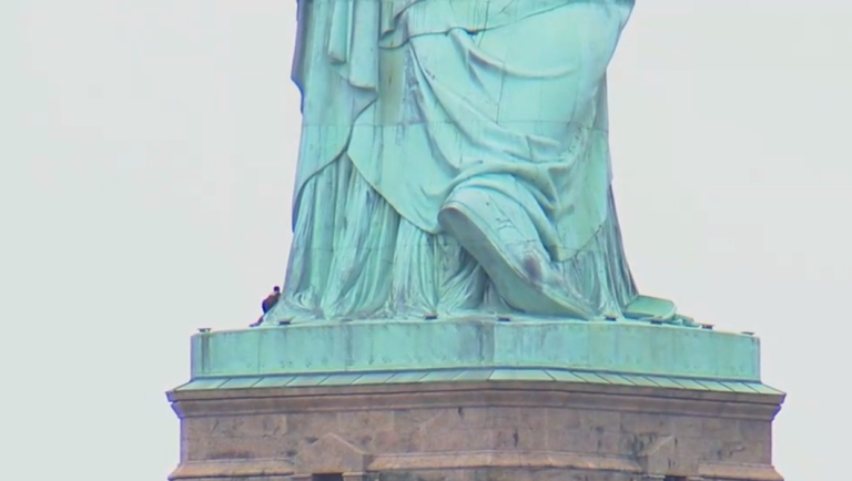 Woman shuts down Liberty Island in New York after scaling the Statue of Liberty