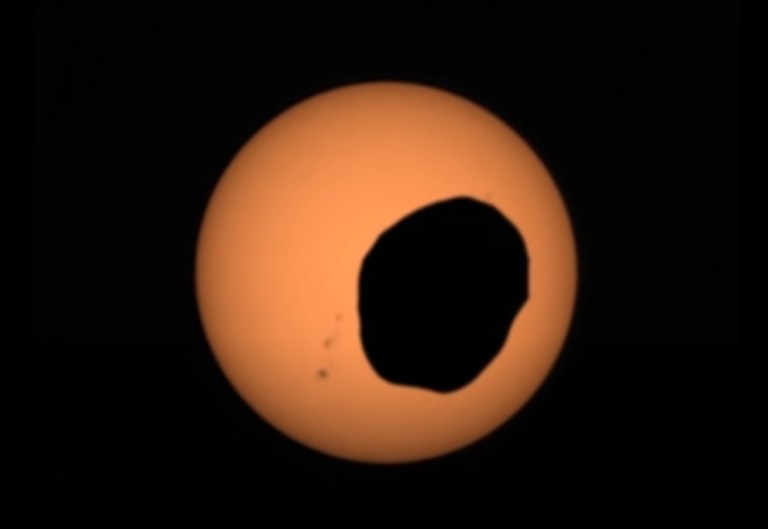 Screenshot of Phobos, one of Mars' moons, crossing in front of the sun. The footage was recorded by NASA's Perseverence rover.