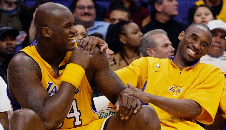 FILE - In this April 15, 2003, file photo, Los Angeles Lakers Shaquille O'Neal, left, and Kobe Bryant share a laugh on the bench while their teammate take on the Denver Nuggets during the fourth quarter at Staples Center in Los Angeles. Bryant, the 18-time NBA All-Star who won five championships and became one of the greatest basketball players of his generation during a 20-year career with the Los Angeles Lakers, died in a helicopter crash Sunday, Jan. 26, 2020.