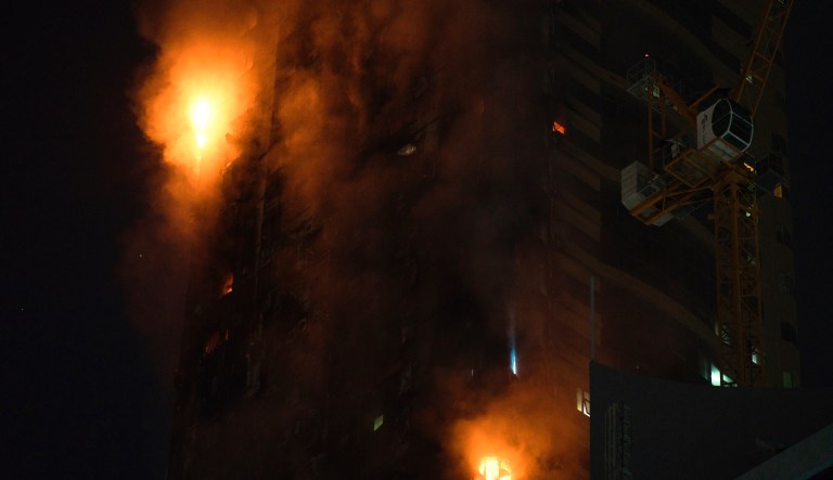 A fire burns on the side of a high-rise building in Sharjah, United Arab Emirates, Tuesday, May 5, 2020. A high-rise tower caught fire Tuesday in the United Arab Emirates and authorities said it wasnât immediately clear what caused the blaze.