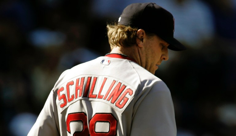 Boston Red Sox pitcher Curt Schilling looks at the ball after giving up three runs during the fourth inning of a baseball game against the Kansas City Royals Monday, April 2, 2007 in Kansas City, Mo. 
