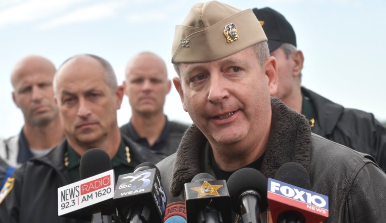 Navy Capt. Tim Kinsella briefs members of the media following a shooting at the Naval Air Station in Pensacola, Fla., Friday, Dec. 6, 2019. The US Navy is confirming that a shooter is dead and several injured after gunfire at the Naval Air Station in Pensacola.