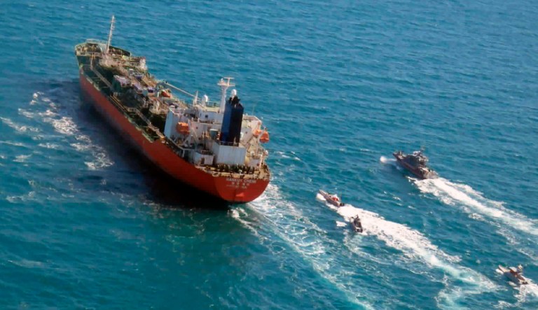 In this Monday, Jan. 4, 2021 file photo released by Tasnim News Agency, a seized South Korean-flagged tanker is escorted by Iranian Revolutionary Guard boats on the Persian Gulf. Iranian state television acknowledged that Tehran seized the oil tanker, MT Hankuk Chemi, in the Strait of Hormuz. A South Korean diplomatic delegation arrived in Iran on Sunday to negotiate the release of a South Korean vessel seized amid an escalating financial dispute between the countries, Iranian state-run media reported. 