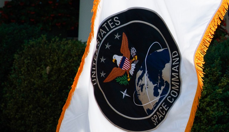 FILE - The flag of the U.S. Space Command is presented during a ceremony for the establishment of the command on Thursday, Aug. 29, 2019, in the Rose Garden of the White House in Washington.