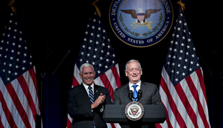 Jim Mattis, U.S. secretary of defense, smiles while introducing U.S. Vice President Mike Pence, left, during an event at the Pentagon in Washington, D.C., U.S., on Thursday, Aug. 9, 2018. President Donald Trump's administration will call on Congress to allocate $8 billion over the next five years to establish the U.S. Space Force as the sixth branch of the military, Pence said today.