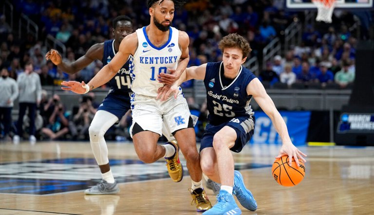 St. Peter's guard Doug Edert (25) drives past Kentucky guard Davion Mintz (10) during the first half of a college basketball game in the first round of the NCAA tournament, Thursday, March 17, 2022, in Indianapolis.