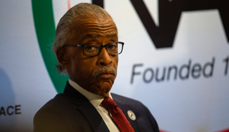 The Rev. Al Sharpton, activist and founder of the National Action Network, looks on before speeches from top Democratic presidential candidates on Thursday, Nov. 21, 2019, in Atlanta. Pete Buttigieg, Cory Booker, Amy Klobuchar, Andrew Yang and Tom Steyer, all presidential hopefuls, spoke at the breakfast event hosted by the National Action Network. (AP Photo/ Ron Harris)
