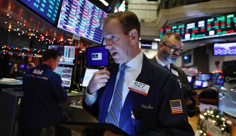 Trader Michael Smyth, center, works on the floor of the New York Stock Exchange, Wednesday, Dec. 11, 2019. Stocks are opening mixed on Wall Street following news reports that US President Donald Trump might delay a tariff hike on Chinese goods set to go into effect this weekend. 