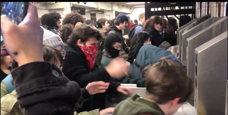 Anti-police protesters jump subway turnstiles in Brooklyn subway station