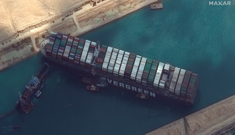 This satellite image from Maxar Technologies shows the cargo ship MV Ever Given stuck in the Suez Canal near Suez, Egypt, Friday, March 26, 2021. A maritime traffic jam grew to more than 200 vessels Friday outside the Suez Canal and some vessels began changing course as dredgers worked frantically to free a giant container ship that is stuck sideways in the waterway and disrupting global shipping.