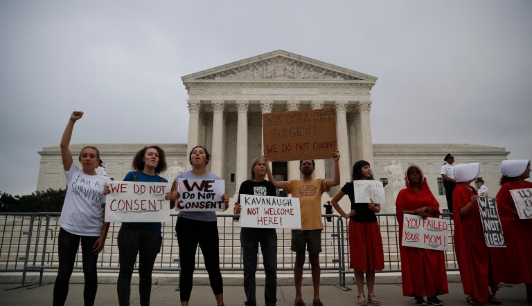 Activists protest in front of the Supreme Court in Washington, Tuesday, Oct. 9, 2018. A Supreme Court with a new conservative majority takes the bench as Brett Kavanaugh, narrowly confirmed after a bitter Senate battle, joins his new colleagues to hear his first arguments as a justice. 