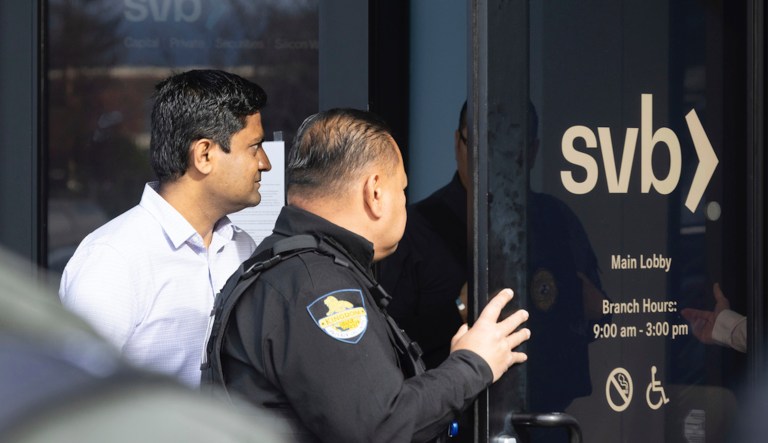 A customer exits Silicon Valley Bank's headquarters in Santa Clara, Calif., on Monday, March 13, 2023. The federal government intervened Sunday to secure funds for depositors to withdraw from Silicon Valley Bank after the bank's collapse. Dozens of individuals waited in line outside the bank to withdraw funds. 