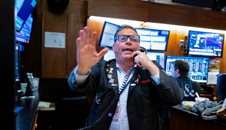 A trader works on the floor at the New York Stock Exchange in New York, Monday, March 13, 2023.