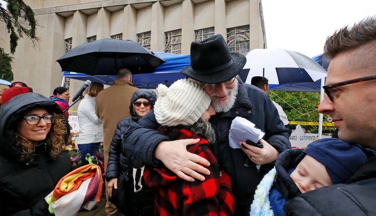 Rabbi Chuck Diamond, center, a former Rabbi at the Tree of Life Synagogue, hugs a woman after leading a Shabbat service outside the Tree of Life Synagogue, Saturday, Nov. 3, 2018 in Pittsburgh. Last Saturday, 11 people were killed and six wounded when their worship was interrupted by a gunman's bullets.