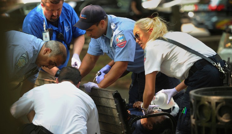 FILE - In this Thursday, Aug. 16, 2018 file photo, paramedics and EMT members respond to one of three simultaneous drug overdose victims on the New Haven Green, a city park in New Haven, Conn. Police swarmed a Connecticut park near Yale University and searched people's homes for drugs Thursday in an effort to prevent more overdoses from a batch of synthetic marijuana blamed for sending more than 70 people to the hospital.