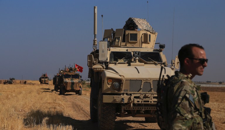 Turkish and American armored vehicles patrol as they conduct joint ground patrol in the so-called "safe zone" on the Syrian side of the border with Turkey, near the town of Tal Abyad, northeastern Syria, Friday, Oct.4, 2019. 