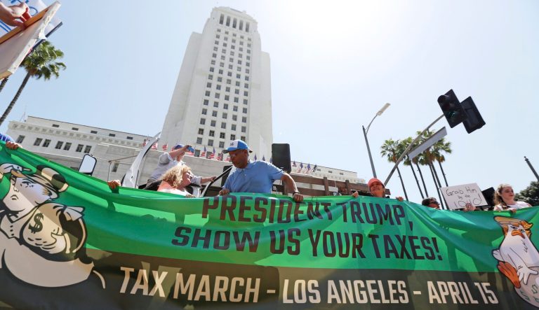Demonstrators protest President Trump's failure to release his tax returns during a rally in front of City Hall  in downtown Los Angeles, Saturday, April 15, 2017. 