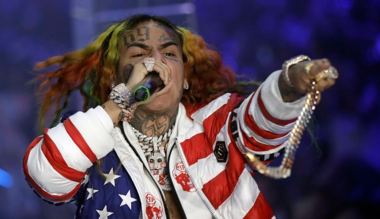 In this Sept. 21, 2018, file photo rapper Daniel Hernandez, known as Tekashi 6ix9ine, performs during the Philipp Plein women's 2019 Spring-Summer collection, unveiled during the Fashion Week in Milan, Italy. Federal authorities say Hernandez is in custody and awaiting a Manhattan court appearance. The Brooklyn-based rapper, whose legal name is Daniel Hernandez, is among four people arrested on racketeering and firearms charges. 