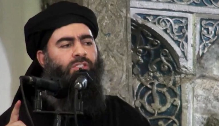 FILE - This file image made from video posted on a militant website July 5, 2014, shows the leader of the Islamic State group, Abu Bakr al-Baghdadi, delivering a sermon at a mosque in Iraq. A media outlet linked to the Syrian military says al-Baghdadi may be holed up in an IS pocket in the eastern town of Boukamal, which government forces and their allies recaptured Thursday, Nov. 9, 2017.