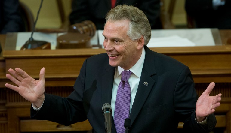 Virginia Gov. Terry McAuliffe gestures as he arrives to address a joint session of the the 2018 session in the House chambers at the Capitol in Richmond, Va., Wednesday, Jan. 10, 2018.