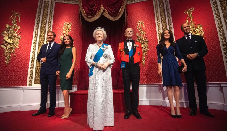 The figures of Britain's Prince Harry and Meghan, Duchess of Sussex, left, in their original positions next to Queen Elizabeth II, Prince Philip and Prince William and Kate, Duchess of Cambridge, at Madame Tussauds in London, Thursday Jan. 9, 2020. Madame Tussauds moved its figures of Prince Harry and Meghan, Duchess of Sussex from its Royal Family set to elsewhere in the attraction.