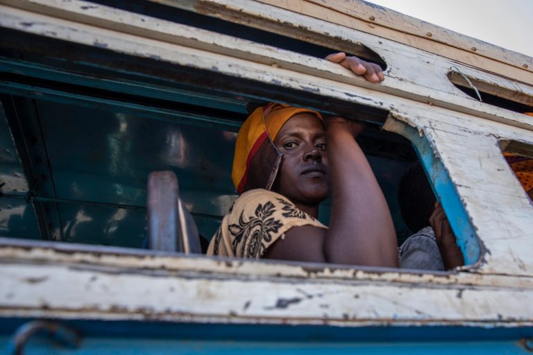 Tigray refugees who fled the conflict in the Ethiopia's Tigray ride a bus going to the Village 8 temporary shelter, near the Sudan-Ethiopia border, in Hamdayet, eastern Sudan, Tuesday, Dec. 1, 2020.