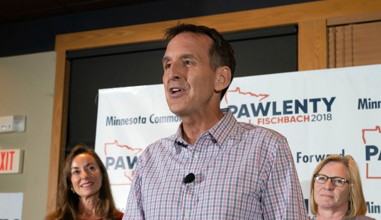 Tim Pawlenty stands with his wife, Mary, background left, and running mate Michelle Fischbach as he concedes his run for governor at his election night gathering at Granite City Food and Brewery, Tuesday, Aug. 14, 2018, in Eagan, Minn.