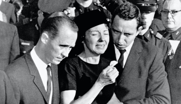 In this Monday, Nov. 25, 1963 file photo, Marie Tippit, widow of police officer J.D. Tippit who was slain during the search for President John F. Kennedy's assassin, is led weeping from Beckley Hills Baptist Church in Dallas after funeral services for her husband. The services began about the time those for Kennedy were ending in Washington.