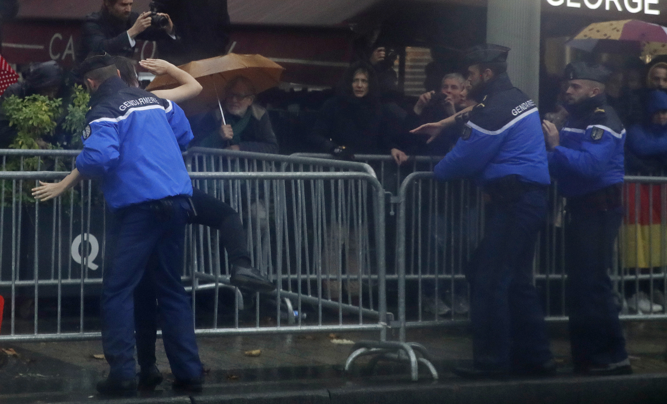 Topless women charge Trump motorcade in Paris