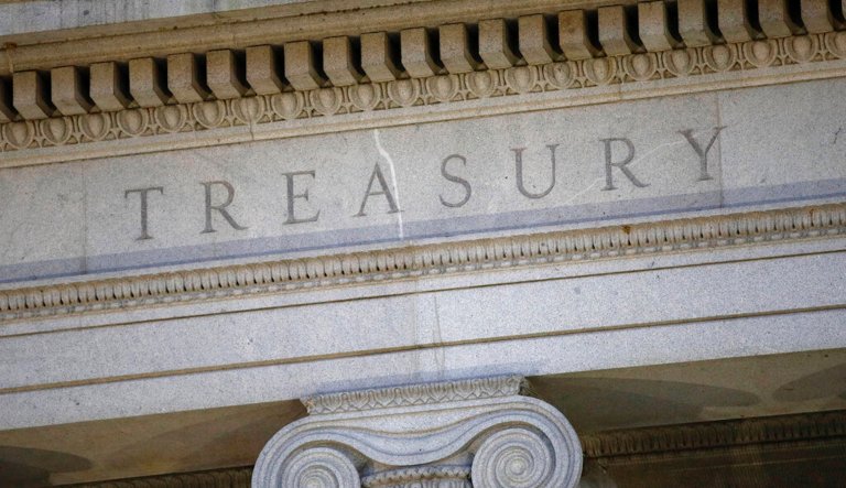 The U.S. Treasury Department building at dusk. Yields on Treasury bills maturing in early June are soaring amid the historic debt ceiling fight between the Biden White House and Republicans, led by Kevin McCarthy.