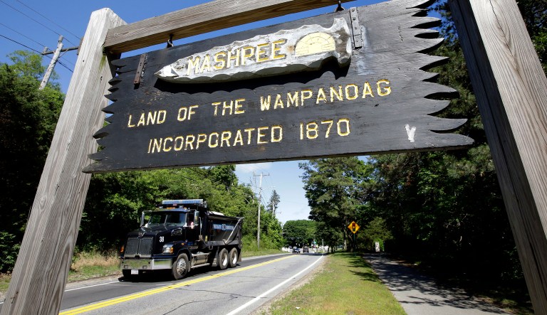 In this Monday, June 25, 2018 photo a wooden sign advises motorists of the location of Mashpee Wampanoag Tribal lands in Massachusetts.