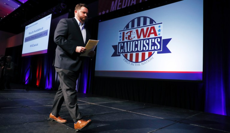 Iowa Democratic Party chairman Troy Price walks off stage after speaking about the delay in Iowa caucus results, Tuesday, Feb. 4, 2020, in Des Moines, Iowa.