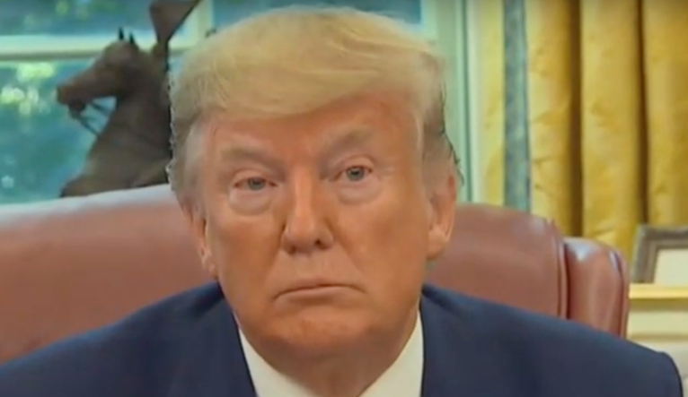 Trump speaks to reporters in the Oval Office.