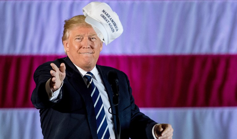 President-elect Donald Trump throws a campaign hat into the audience while speaking at a rally in a DOW Chemical Hanger at Baton Rouge Metropolitan Airport, Friday, Dec. 9, 2016, in Baton Rouge, La.