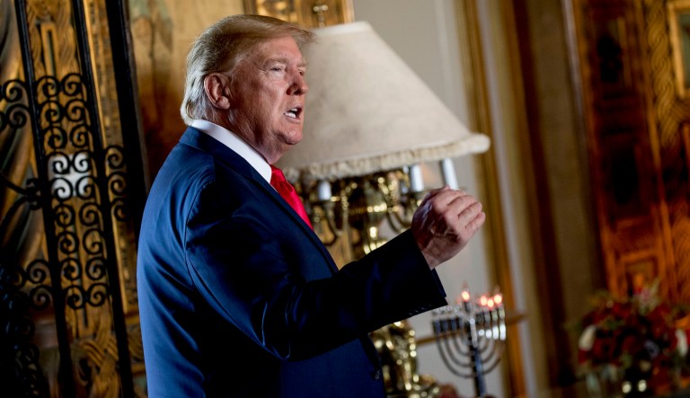 President Donald Trump speaks to members of the media following a Christmas Eve video teleconference with members of the military at his Mar-a-Lago estate in Palm Beach, Fla., Tuesday, Dec. 24, 2019.