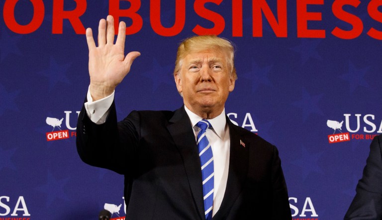 Rep. Evan Jenkins, R-W.Va., left, and West Virginia Attorney General Patrick Morrisey, right, watch as President Donald Trump arrives for a roundtable discussion on tax policy, Thursday, April 5, 2018, in White Sulphur Springs, W.Va.
