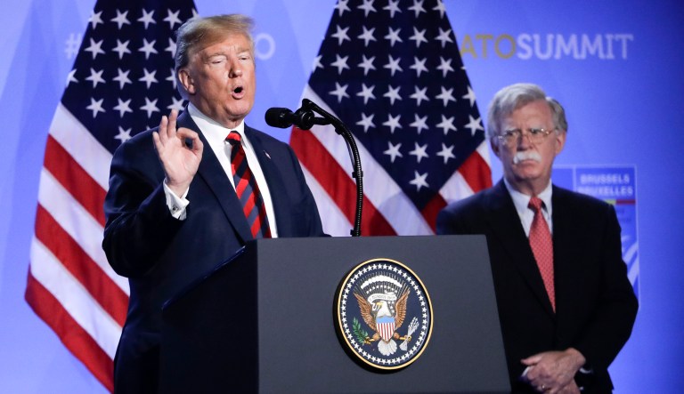 U.S. President Donald Trump, left, is flanked by national security adviser John Bolton, right during a press conference after a summit of heads of state and government at NATO headquarters in Brussels, Belgium, Thursday, July 12, 2018.