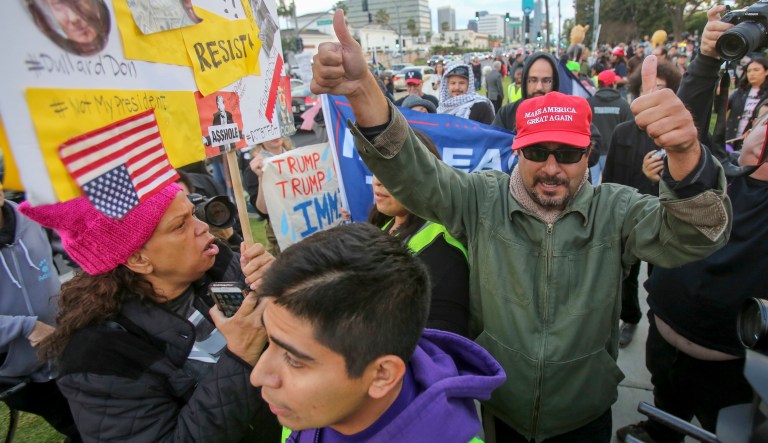 Supporters and protesters confront each other during a rally before a scheduled visit by President Trump on March 13, 2018, in Beverly Hills, Calif.