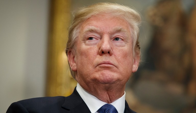 President Donald Trump listens to Vice President Mike Pence speak before signing a policy directive to send American astronauts back to the moon, and eventually Mars, in the Roosevelt Room of the White House, Monday, Dec. 11, 2017, in Washington.