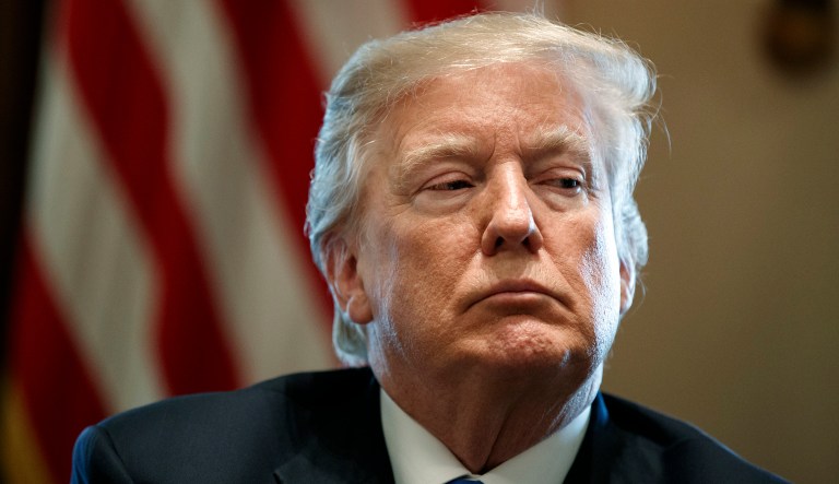President Donald Trump listens during a meeting with lawmakers on immigration policy in the Cabinet Room of the White House, Tuesday, Jan. 9, 2018, in Washington. Trump is lashing out at Sen. Dianne Feinstein for releasing the transcript of an interview with the co-founder of a political opposition firm that commissioned a dossier of allegations about Trump's presidential campaign and Russia.