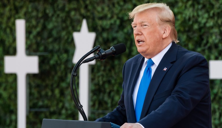 U.S. President Donald Trump speaks from the podium during a ceremony at the Normandy American Cemetery and Memorial in Colleville-sur-Mer, France, on Thursday, June 6, 2019. President Donald Trump's European sojourn continues with a visit to France for the 75th anniversary of theÂ D-DayÂ landings.