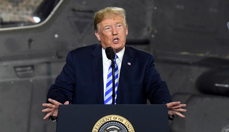 FILE - In this Aug. 13, 2018 file photo, President Donald Trump speaks before signing a $716 billion defense policy bill named for Sen. John McCain  in Fort Drum, N.Y.  Trump says heâs asking federal regulators to look into the effectiveness of the quarterly financial reports that publicly traded companies are required to file.  In a tweet early Friday, Aug. 17, Trump said that after speaking with âsome of the worldâs top business leaders,â heâs asked the U.S. Securities and Exchange Commission to determine whether shifting to a six-month reporting regimen would make more sense.