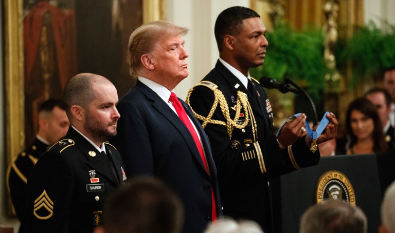 President Donald Trump stands with former Army Staff Sgt. Ronald J. Shurer II before presenting him with the Congressional Medal of Honor for actions in Afghanistan, in the East Room of the White House, Monday, Oct. 1, 2018, in Washington.