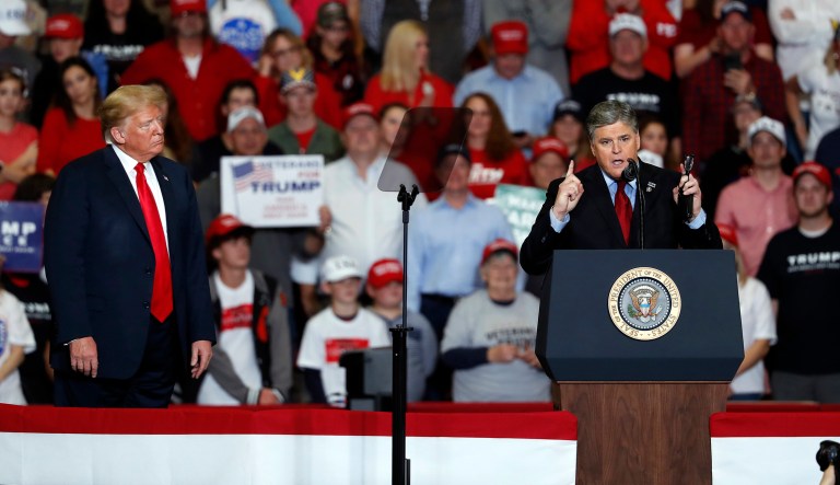 Television personality Sean Hannity, right, speaks as President Donald Trump listens during a campaign rally Monday, Nov. 5, 2018, in Cape Girardeau, Mo.