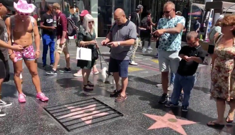 Street artist places jail bars over Trump’s Hollywood star