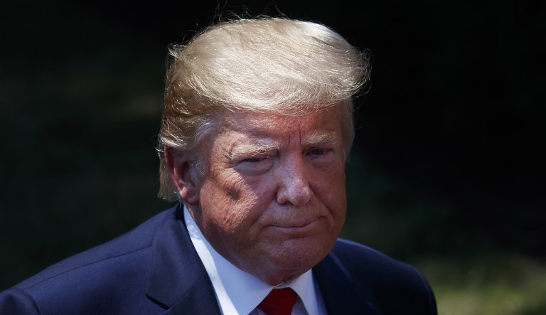 U.S. President Donald Trump listens to a question from a member of the media on the South Lawn of the White House in Washington, D.C., U.S., on Tuesday, July 30, 2019.