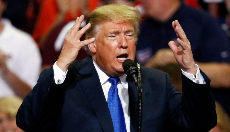 President Donald Trump gestures as he speaks at a rally Tuesday, Oct. 2, 2018, in Southaven, Miss.