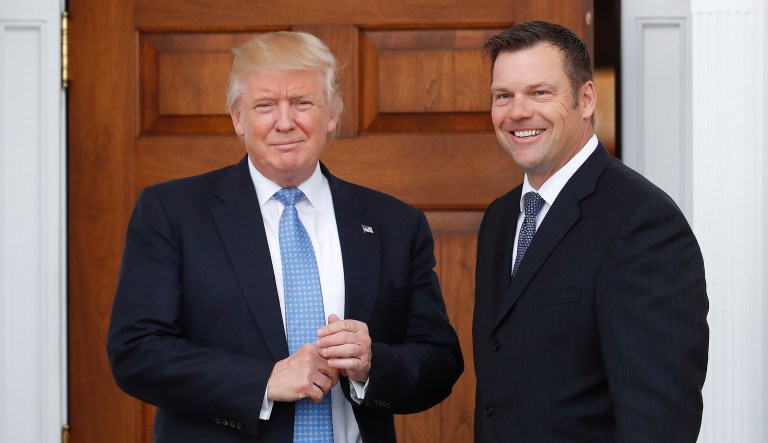 FILE - In this Nov. 20, 2016, file photo, Kansas Secretary of State Kris Kobach, right, holds a stack of papers as he meets with then President-elect Donald Trump at the Trump National Golf Club Bedminster clubhouse in Bedminster, N.J. Civil rights advocates say Kobach is trying to hide materials that undercut his public claim that substantial numbers of noncitizens have registered to vote. The American Civil Liberties Union obtained the documents as part of its federal civil lawsuit in Kansas challenging the state's proof-of-citizenship document requirement. It wants to court to remove the confidential designation Kobach placed on materials he was photographed taking into a November meeting.